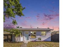 Charming single-story home featuring a freshly painted exterior, well-maintained lawn, and inviting front entrance with a light blue door at 679 71St N Ave, St Petersburg, FL 33702
