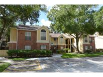 Brick and siding exterior with mature landscaping, creating a welcoming curb appeal for this condo complex at 8647 Mallard Reserve Dr # 104, Tampa, FL 33614