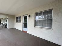 Exterior view of the building with a porch, door and windows at 946 Virgina # 304, Dunedin, FL 34698