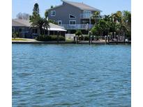 Waterfront two-story home featuring a private dock and a beautiful view of the serene open water at 17404 1St E St, Redington Shores, FL 33708