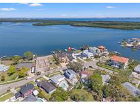 Stunning aerial view of waterfront homes with docks, surrounded by beautiful blue water and lush greenery at 1843 Bayou Grande Ne Blvd, St Petersburg, FL 33703
