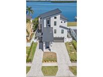Stunning three-story waterfront home with a modern design and a spacious driveway at 1843 Bayou Grande Ne Blvd, St Petersburg, FL 33703
