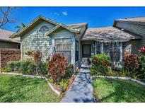 Well maintained home with manicured front yard, and mature landscaping at 2446 Bentley Dr, Palm Harbor, FL 34684