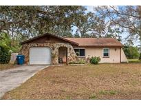 Charming single-story home featuring stone accents and an attached garage at 9287 Horizon Dr, Spring Hill, FL 34608