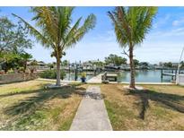 Gorgeous waterfront view with a private dock and lush landscaping perfect for enjoying the waterfront lifestyle at 14184 W Parsley Dr, Madeira Beach, FL 33708