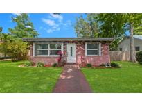 Charming brick home featuring a well-manicured lawn and bright white front door at 4424 19Th N St, St Petersburg, FL 33714