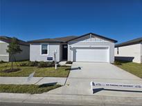 Well-maintained home featuring a wide driveway, lush lawn, and inviting curb appeal, perfect for prospective homeowners at 212 Lazy Shore Dr Dr, Nokomis, FL 34275