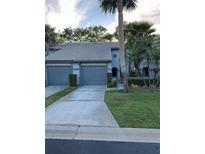 Charming townhome with a two-car garage and mature landscaping at 4237 Brentwood Park Cir, Tampa, FL 33624