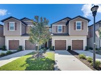 Charming townhomes with attached garages, manicured lawn and beautiful landscaping at 5312 Sylvester Loop, Tampa, FL 33610