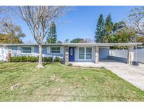 Charming single-story home with a well-maintained lawn, stone accents, and carport at 10447 110Th Ave, Largo, FL 33773