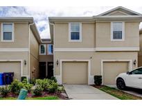 Inviting townhome with a beige exterior, two-car garage, and manicured landscaping in a desirable neighborhood at 2153 Broadway View Ave, Brandon, FL 33510