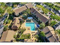 Aerial view of a community pool surrounded by lounge chairs and well-maintained landscaping at 4006 Crockers Lake Blvd # 212, Sarasota, FL 34238