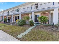 Charming condo featuring a front yard with stepping stones leading up to the entrance and well-maintained landscaping at 4742 Azalea Dr # 106, New Port Richey, FL 34652