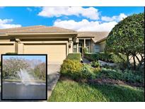 Charming home with a tan exterior, attached garage, beautiful landscaping, and community water view at 4813 Michelle Ln, Palm Harbor, FL 34684