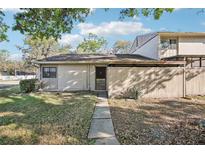 Charming home exterior with a walkway to the front door and a wooden fence creating a private courtyard at 8001 Jasmine Dr # 8001, Temple Terrace, FL 33637