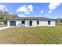 Charming one-story home featuring a well-manicured lawn, single car garage, and modern design elements at 114 25Th E St, Palmetto, FL 34221