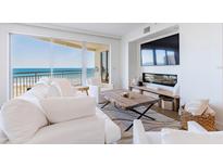 Bright and airy living room with ocean views, comfortable seating, and a modern fireplace at 1200 Gulf Blvd # 902, Clearwater Beach, FL 33767