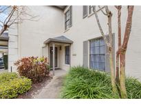 Charming home featuring a covered front entrance surrounded by lush landscaping at 13140 Village Chase Cir # 13140, Tampa, FL 33618
