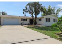 Charming single-story home featuring a well-manicured front yard and attached garage at 3094 Vernon Ter, Largo, FL 33770