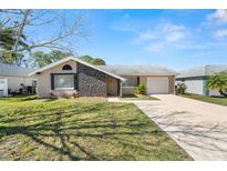 Charming single-Gathering home with well-maintained lawn, neutral paint, and a stone accent wall at 3639 Richboro Dr, Holiday, FL 34691
