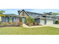 Charming two-story home featuring stone accents, a well-manicured lawn, and a two-car garage at 5115 Abisher Wood Ln, Brandon, FL 33511