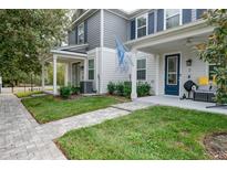 Charming townhome with a covered front porch and manicured lawn at 6615 S Manhattan Ave # 2, Tampa, FL 33616