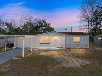 Charming single-story home featuring a carport, front yard, and freshly painted exterior at 7305 Windsor St, Hudson, FL 34667