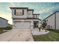 Charming two-story home featuring a two-car garage and beautifully landscaped front yard at 7446 Yale Harbor Dr, Wesley Chapel, FL 33545