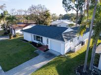 Charming single-story home with a well-manicured lawn, attached garage and lovely landscaping at 811 Helmsman Way, Palm Harbor, FL 34685