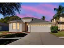 Charming single-Gathering home showcasing a two-car garage and manicured lawn at 8329 Moccasin Trail Dr, Riverview, FL 33578
