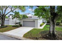 Charming single-story home with mature trees and a well-manicured front yard at 13621 Twin Lakes Ln, Tampa, FL 33618