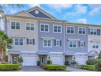 Charming townhome exteriors featuring craftsman-style details, attached garages, and well-maintained landscaping at 4043 Rocky Shores Dr, Tampa, FL 33634