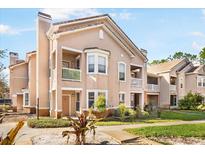 Inviting two-story condo showcasing charming balconies and lush landscaping on a sunny day at 17978 Villa Creek Dr, Tampa, FL 33647
