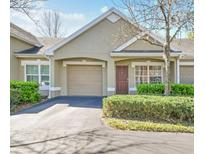 Charming home with a garage, well-maintained landscaping, and a cozy front entrance, offering great curb appeal at 3638 Trafalgar Way # 103, Palm Harbor, FL 34685