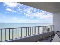 Condo balcony view of the water with seating and a white railing on a sunny day with blue skies and white clouds at 5279 Isla Key S Blvd # 313, St Petersburg, FL 33715