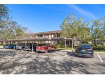 Exterior view of covered parking spaces available at the residential complex on a sunny day at 725 83Rd N Ave # 205, St Petersburg, FL 33702