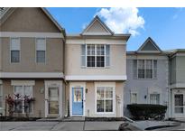 Charming townhome featuring a blue door and neutral stucco exterior at 11308 Grandville Dr, Temple Terrace, FL 33617