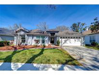 Charming home features a manicured lawn, two-car garage, and inviting front entrance at 3115 Bent Creek Dr, Valrico, FL 33596