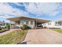 Charming single-story home featuring a covered carport and well-maintained front yard at 36745 Kimela Ave, Zephyrhills, FL 33542