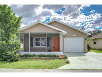 Charming single-Gathering home with a cozy screened-in porch and well-maintained landscaping at 4772 Silver Cir, Zephyrhills, FL 33541