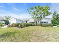 Charming single-story home with a well-manicured lawn and mature landscaping at 8490 7Th N Ln, St Petersburg, FL 33702