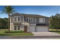 Charming two-story home with a gray exterior, complemented by a well-maintained lawn and a two-car garage at 13035 Ruby Gold Ct, Wimauma, FL 33598