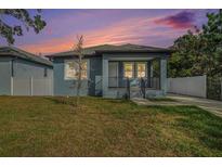 Charming home featuring a cozy front porch and well-maintained lawn at 3405 Phillips St, Tampa, FL 33619