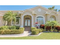 Charming single-story home features a well-manicured lawn and beautiful landscaping at 946 Allegro Ln, Apollo Beach, FL 33572