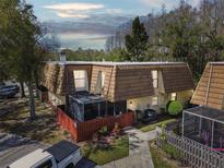 Charming townhouse featuring a fenced yard and distinctive wood shake roof at 12738 Wood Trail Blvd, Tampa, FL 33625