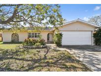 Charming single-story home featuring a well-maintained front yard and attached two-car garage at 12766 91St Ave, Seminole, FL 33776