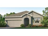 Charming single-story home featuring a neutral color, a two-car garage, and well-maintained landscaping at 17214 Wheatberry Blvd, Parrish, FL 34219