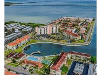 Stunning aerial view of waterfront condos, a pool, and the bay in a vibrant community at 19029 Us Highway 19 N # 12E, Clearwater, FL 33764