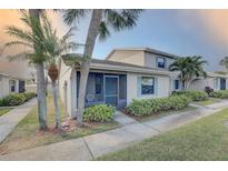 Inviting home exterior featuring lush landscaping and a screened-in porch at 2131 Ridge S Rd # 132, Largo, FL 33778