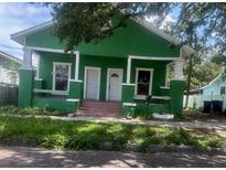 Charming green home with brick pillars and a cozy front porch at 2410 Harper St, Tampa, FL 33605